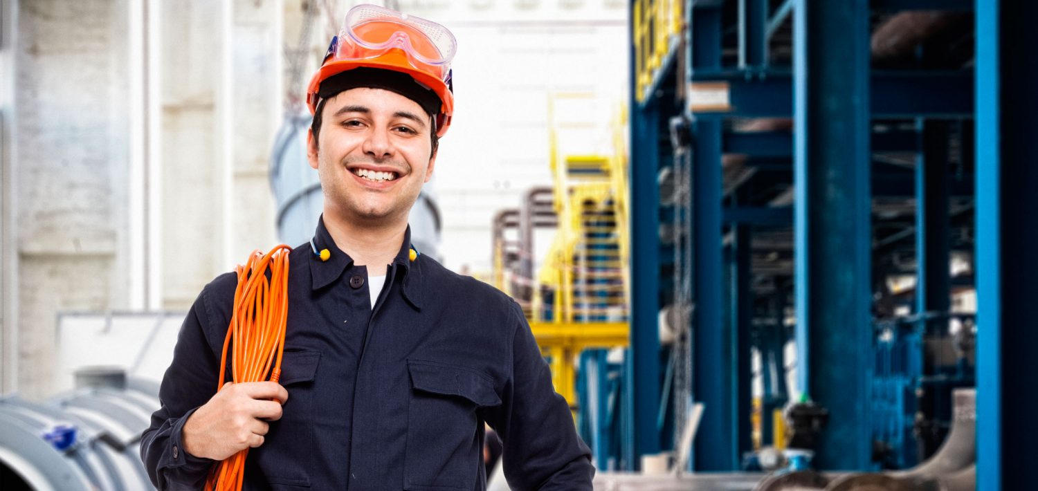 Electrician standing with his equipment and smiling.