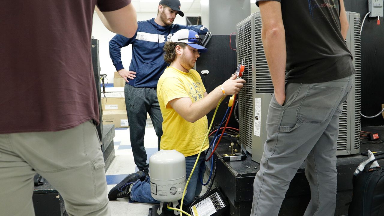 A Penn Commercial HVAC-R student tests an air conditioning unit