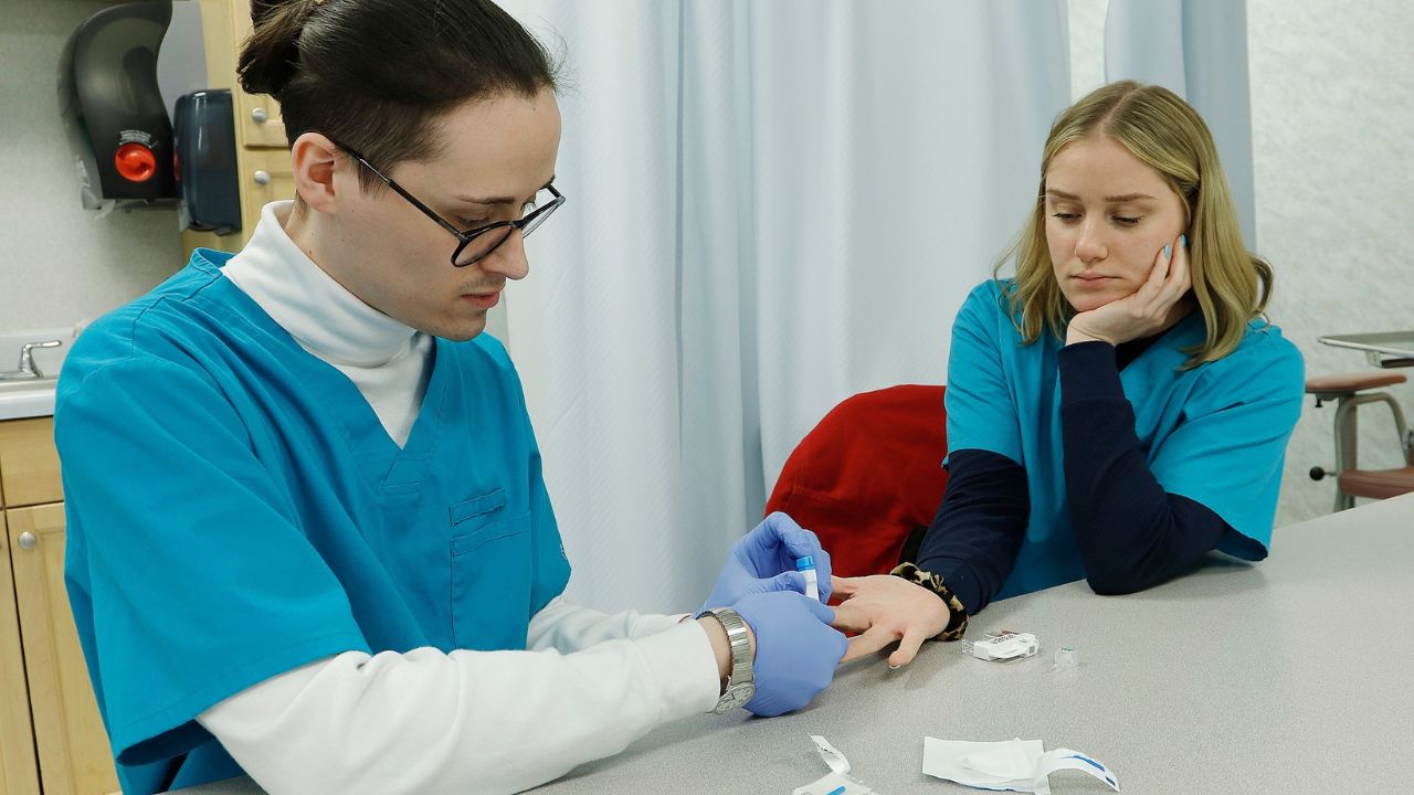 Penn Commercial phlebotomy students practice drawing blood